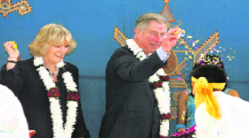 Britains Prince Charles and the Duchess of Cornwall throw flower petals over schoolchildren who had performed for them at the Sri Swaminarayan Mandir school, in London on Wednesday during Holi celebrations.