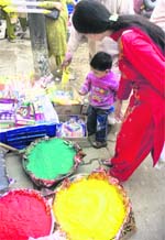 A women buys colours in Kanak Mandi in Jammu. 