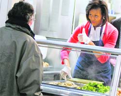 TOP SERVICE: US first lady Micheile Obama serves food at Miriams Kitchen in Washington that provides meals and support to neary 250 homeless men and women in the city