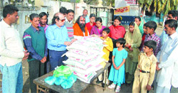 Representatives of social and trade organisations distribute aid to Pakistani Hindu families in Amritsar on Saturday.