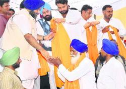 Deputy Chief Minister Sukhbir Singh Badal welcomes Congress activists who joined the SAD at Chak Attar Singh Wala village in Bathinda on Saturday.
