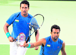 Leander Paes (R) hits a return against Taiwan as Mahesh Bhupathi looks on during their Davis Cup Asia-Oceania Group I second round in Kaohsiung on Saturday.