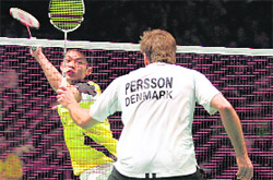 Chinas Lin Dan (L) returns a shot in his quarterfinal match against Denmarks Joachim Persson during the Badminton All England Open Championships at The National Indoor Arena in Birmingham on Friday.