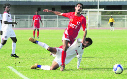 JCT FCs Amandeep Singh is challenged by Air Indias Syed Farid during their I-League match at the Guru Nanak stadium in Ludhiana on Saturday.