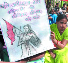 Members of the Pragatisheel Mahila Sangathan stage a dharna at Parliament Street demanding equal treatment for women on the occasion of International Women's Day in New Delhi