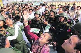 Myanmar leader General Than Shwes wife Daw Kyaing Kyaing (C) throws bank notes in the air as she donates money during a consecration ceremony of the Uppatasanti Pagoda, a repica of Yangons famed Shwedagon Pagoda, in Mayanmars administrative capital of Naypyidaw