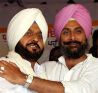 PPCC general secretary Raninder Singh and MLA Harminder Singh Jassi hug each other during a party rally held in Bathinda on Monday evening.