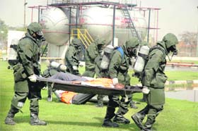 Workers carry out a disaster management operation as part of a mock drill at Hero Honda plant in Gurgaon