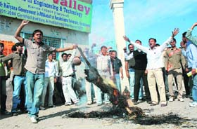 FIERY TEMPERS: Students of the Doon Valley Institute of Engineering and Technology burn effigy of the management of the institution in front of the college gate