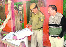 Police collecting evidence from a house in Shivpuri where a woman was murdered.