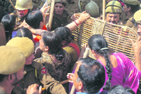 The police beats up members of the J&K Home Guards Association at City Chowk in Jammu on Monday.