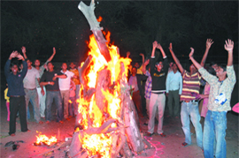 Holi is all ha ha, hee heeA group of youngsters enjoy Holika Dahan at Mata Sundari Road in New Delhi