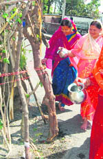 Women perform 'Holika Dahan' on the eve of Holi in Dehradun on Tuesday.