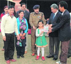 Deputy Commissioner, Udhampur, Ajay Khajuria felicitates Bhooma Khajuria at a function.