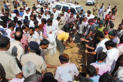 The Gurgaon police buries carcasses of cows that were recovered on Wednesday in Hasanpur village near Gurgaon.