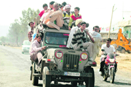 An overloaded maxi cab on the Gurgaon-Mewat road.