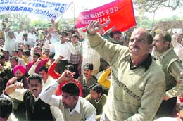 Members of the PDD Daily Wagers Association protest in support of their demands at Indira Chowk in Jammu on Thursday.
