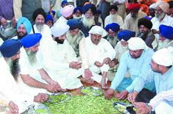 Former cabinet minister Bikram Singh Majithia and members of the Shiromani Akali Dal from Majitha perform service at the community kitchen hall in the Golden Temple.