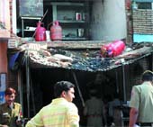 Delhi police personnel inspect the site where a cooking gas cylinder exploded in a sweets shop in Rohinis Sector 7 on Friday morning. 