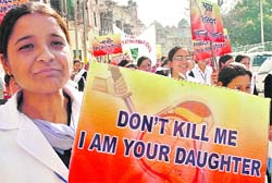 A girl holds a banner at a rally against female foeticide in Jammu. 