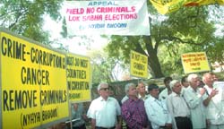 Activists of Nyaya Bhoomi, an NGO, protest against criminals contesting elections, in New Delhi 