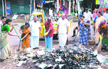 Volunteers sweep roads and pavements of the temple town