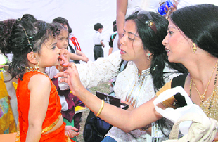 A girl gets ready for the cultural programme of a school in Dehradun on Sunday.