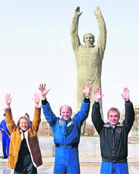 Backup crew of the Soyuz TMA-14 space mission (from left) entrepreneur Esther Dyson of Switzerland, US astronaut Jeffrey Williams and Russian cosmonaut Maxim Suraev pose for a picture in front of the monument to Yuri Gagarin at Baikonur