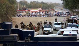 A group of radical Sikhs squatting on the Talwandi Sabo-Chandigarh road at Kot Shahmir near Bathinda on Monday. Cops have been deployed in strength to prevent fresh trouble. 