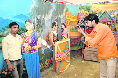 A young man gets himself clicked with a cut-out of actress Kareena Kapoor at Jhanda Mela in Dehradun on Monday.