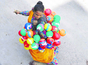 A woman sells water balloons in Karnal.