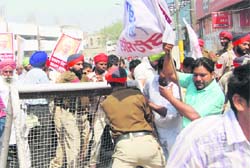 Activists of the Shaheed Bhagat Singh Naujawan Sabha and student unions force entry  into the Jallianwala Bagh in Amritsar on Monday. 