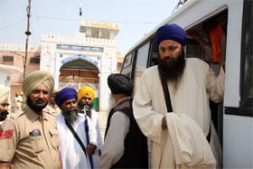 Radical Sikh leader Baljeet Singh Daduwal alighting a police bus outside the jail in Bathinda