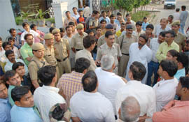 Policemen gather outside the private clinic in Gurgoan where a two-year-old girl died on Tuesday.