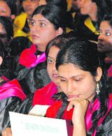 A student looks at her degree during the convocation of the KVA DAV College for Women in Karnal on Tuesday.