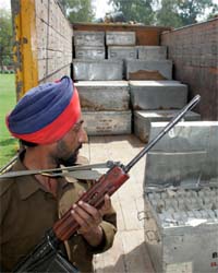 A cop keeps the vigil as electronic voting machines (EVMs) are unloaded inside the Mini-Secretariat in Bathinda