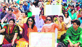 Teachers of DAV College, Sector 10, protest at the Sector 17 Plaza in Chandigarh on Wednesday.
