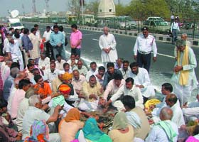 People perform hawan on the Dwarka flyover where accidents have claimed eight lives, in New Delhi