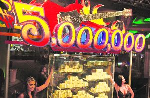 Models stand next to what is being called a first-of-its-kind exhibit of five million dollars in cash at the Seminole Hard Rock Hotel and Casino on Wednesday in Florida, US.