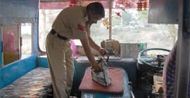 A policeman inspects the bus that killed a schoolboy in Gurgaon on Thursday.