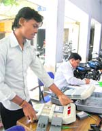 A technician repairs an elctronic voting machine in Dehradun on Thursday