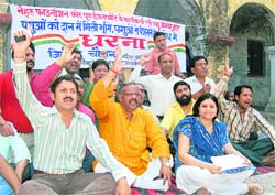 Members of the Nehru Foundation for Youth Development protest against shifting of the veterinary hospital in Dehradun on Thursday. 