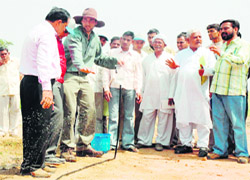 Drip irrigation technology entrepreneur Peter Frykman and other agricultural experts explain a technique to farmers at a workshop conducted in Pathredi village near Gurgaon.