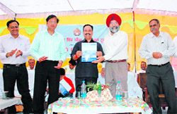 Dr AK Srivastava, director, NDRI, Karnal, releases a souvenir in Sonepat.