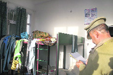 A policeman inside a room of the institute where the alleged rape took place.