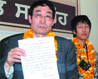 Dr Norio Okaguchi shows his letter written in Punjabi in Amritsar.