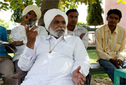 Major Singh, a senior member of the political wing of the Dera Sacha Sauda, discussing the situation with followers of the sect at Salabatpura on Friday.