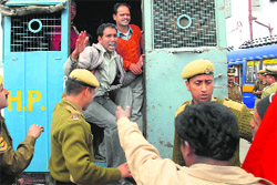 Police arresting workers of Bishop Cotton School and CITU members, who were protesting against the management and principal in Shimla on Friday.