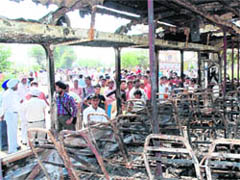 The remains of an HRTC bus that was set ablaze by villagers on Friday after the police resorted to firing in Dhanoli village near Assandh.