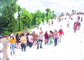 Tourists enjoying after the snowfall at Kufri, about 13 km from Shimla
